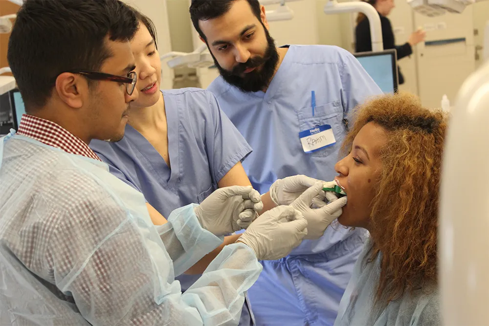 a group of people in a hospital room