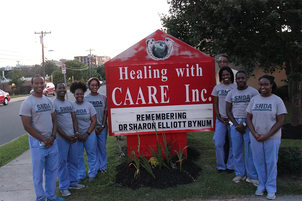 a group of people standing in front of a sign