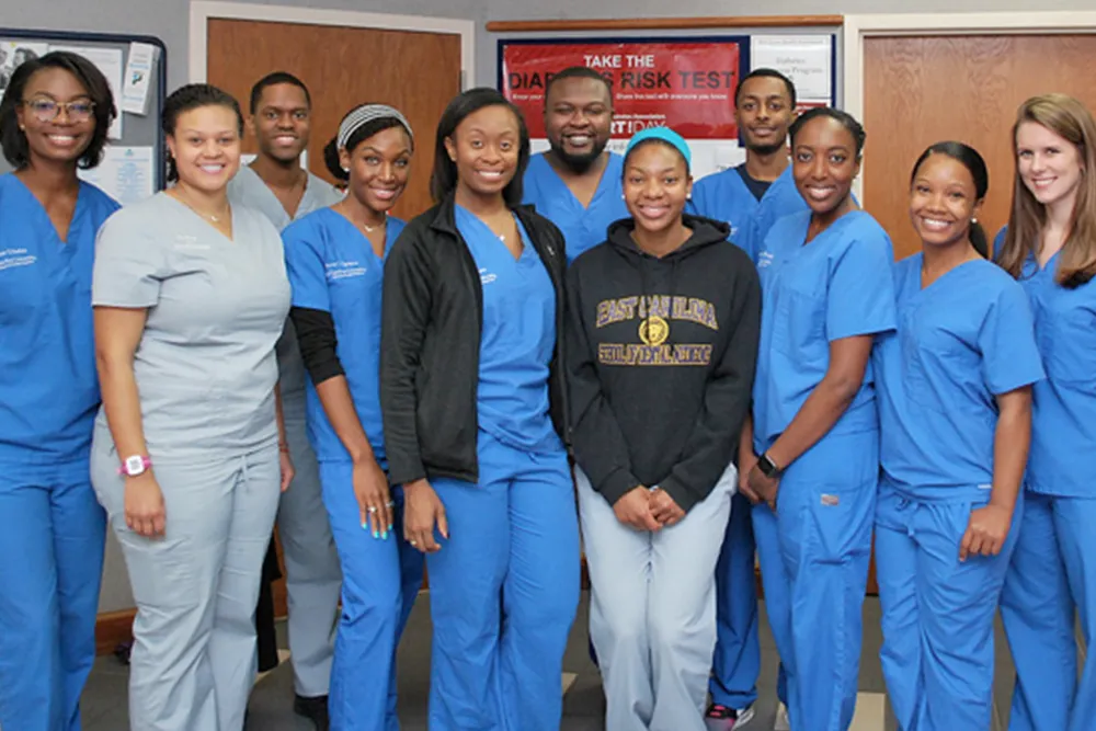 a group of people in scrubs posing for a picture
