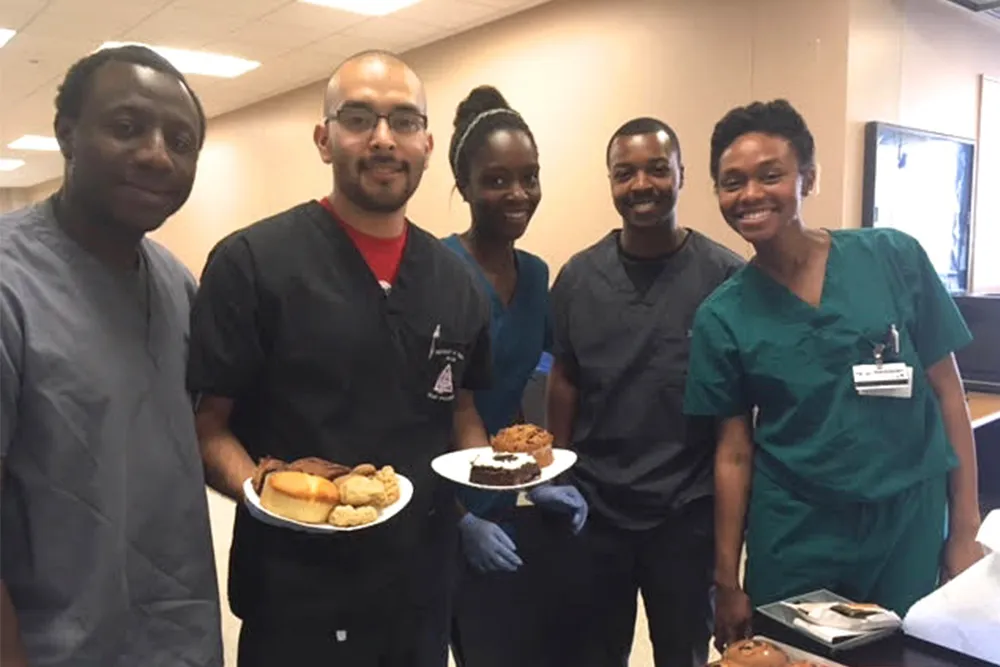 a group of doctors holding plates of food