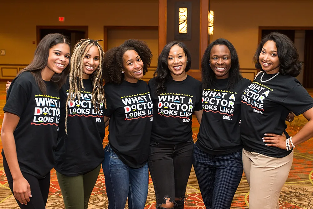 a group of women standing next to each other