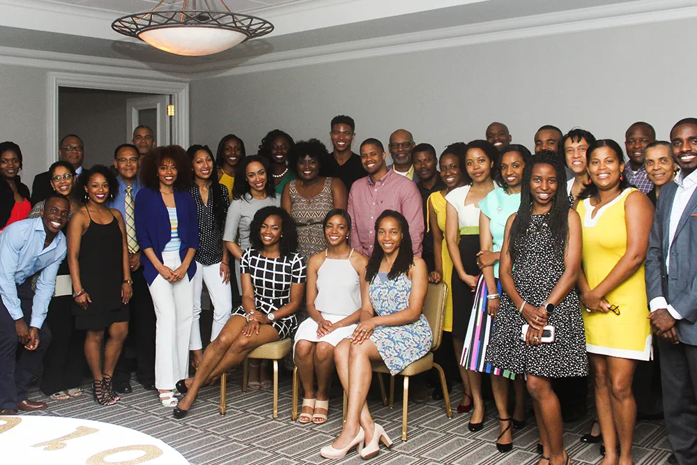 a group of people standing and sitting in a room