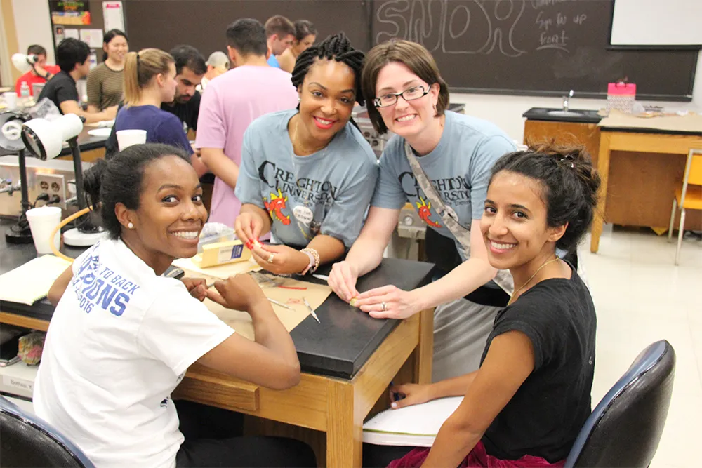 a group of girls sitting at a table together